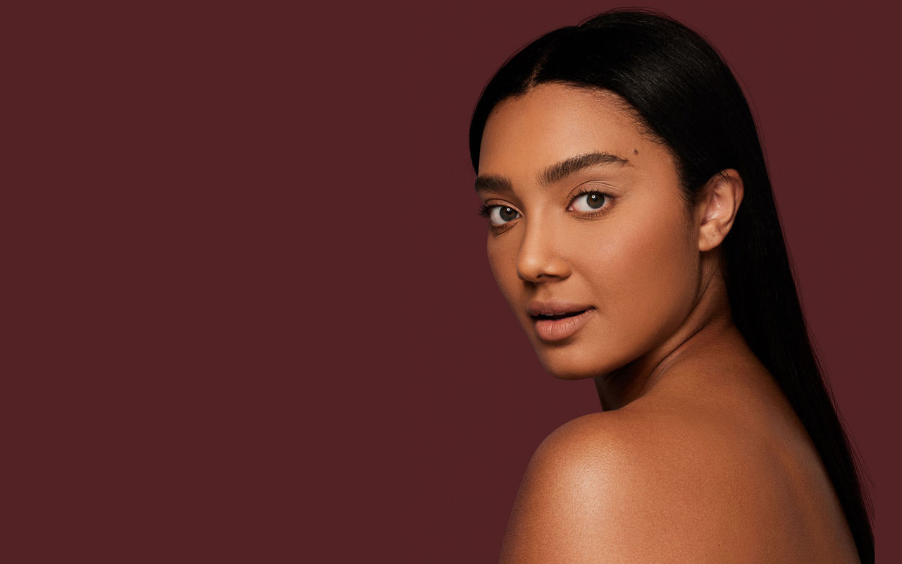 Woman looking over her shoulder with smooth skin